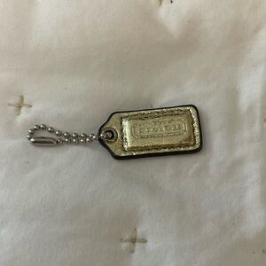Mini gold coach tag with silver attachments